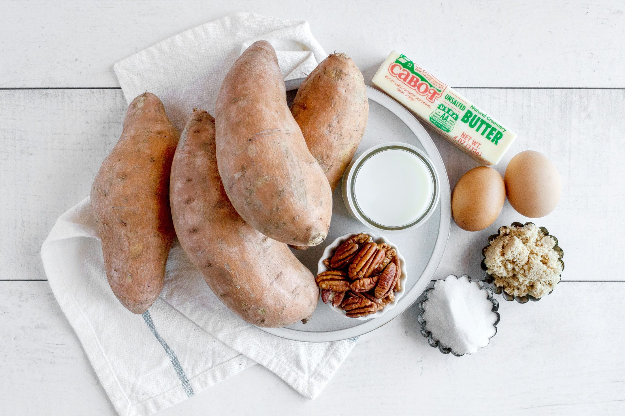 ingredients for sweet potato casserole on a wooden surface