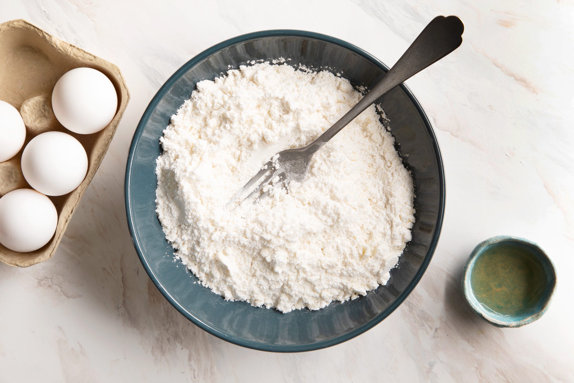 mixing gluten free pie crust in a bowl with a fork