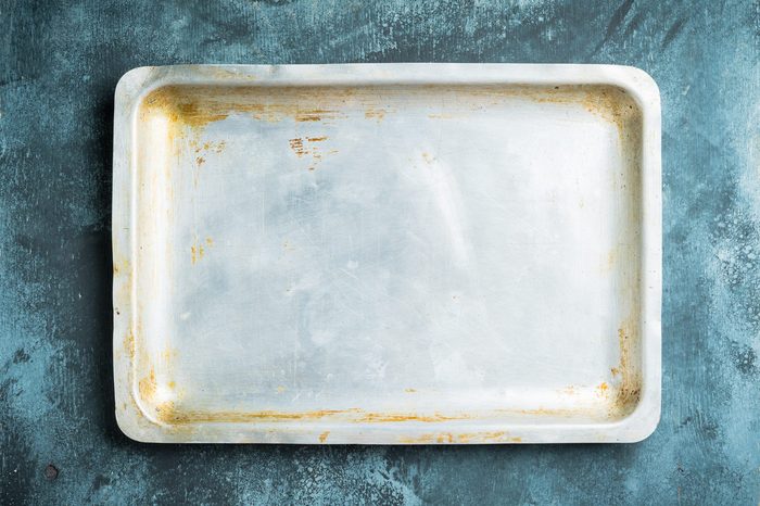 Clean baking sheet on the rustic background