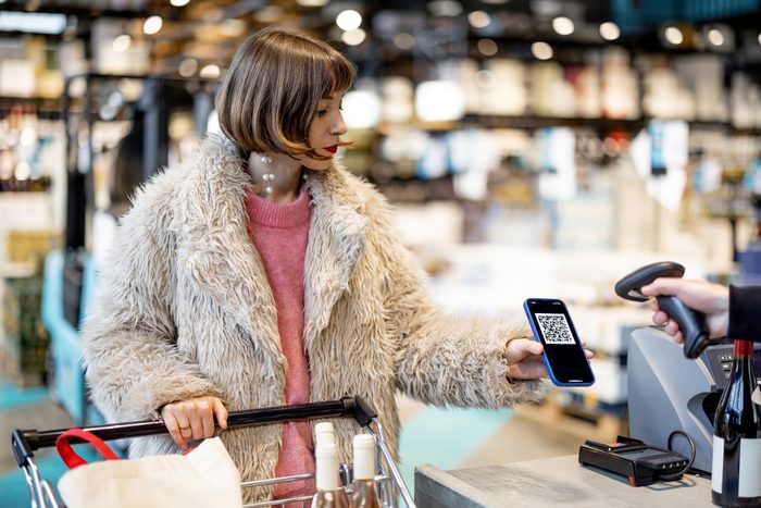 Woman buying with QR code