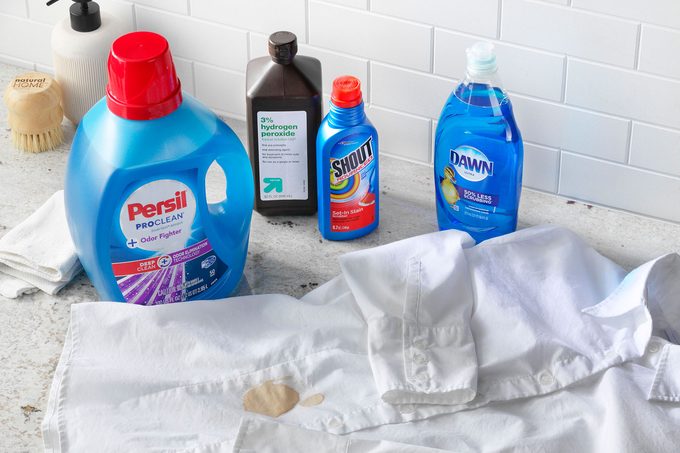 Soy Sauce stained shirt near cleaning supplies arranged on a counter top