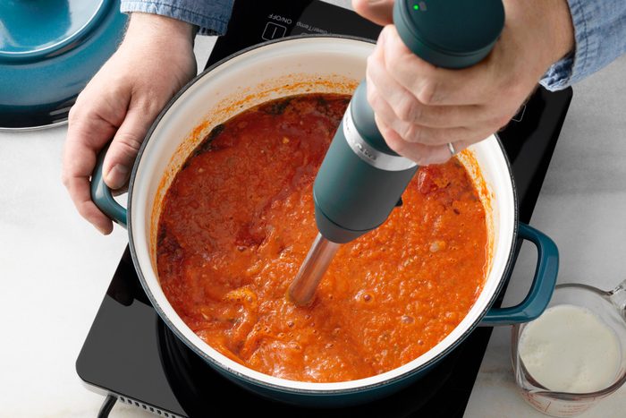 using an immersion blender to make copy cat Panera tomato soup