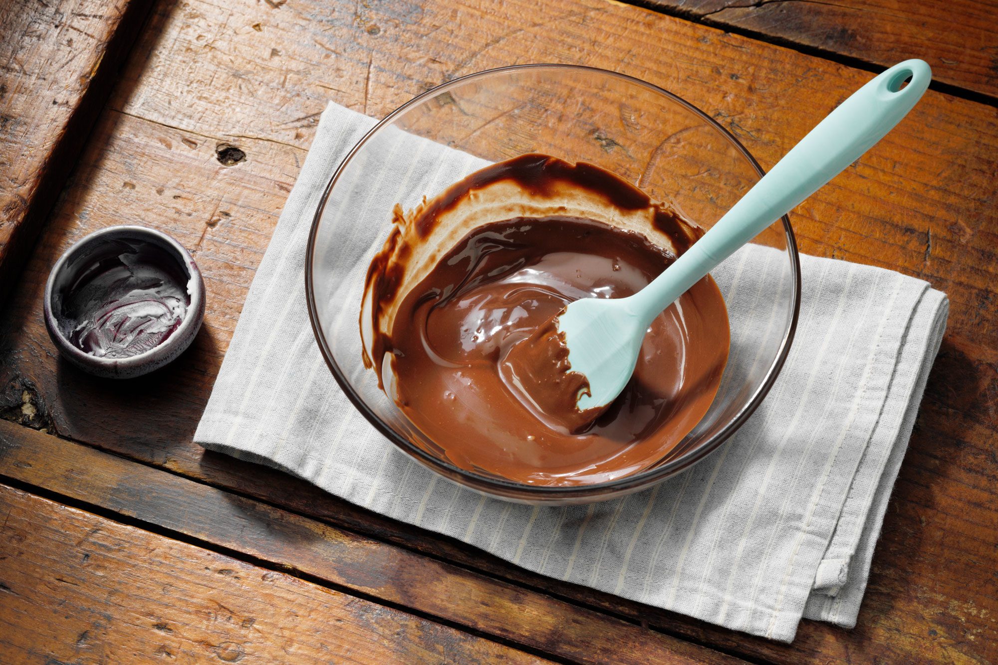Melted Chocolate chips In a Bowl On Wood Surface