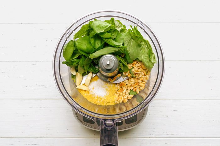 Vegan Pesto ingredients inside a food processor; top down view