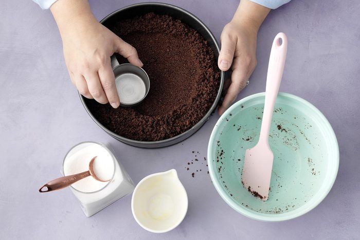 A Person Crushing Chocolate Mixture in a Bowl