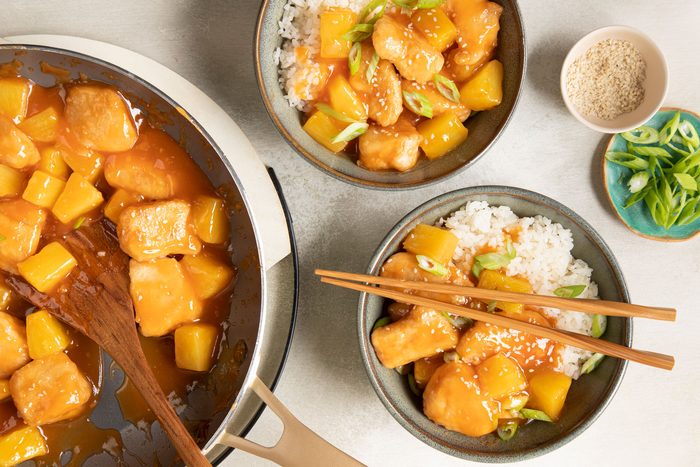 Sweet And Sour Chicken with rice bowl and chopsticks