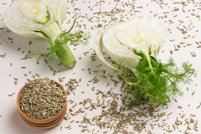 Two halves of fennel bulb, fennel seeds. Healthy food.