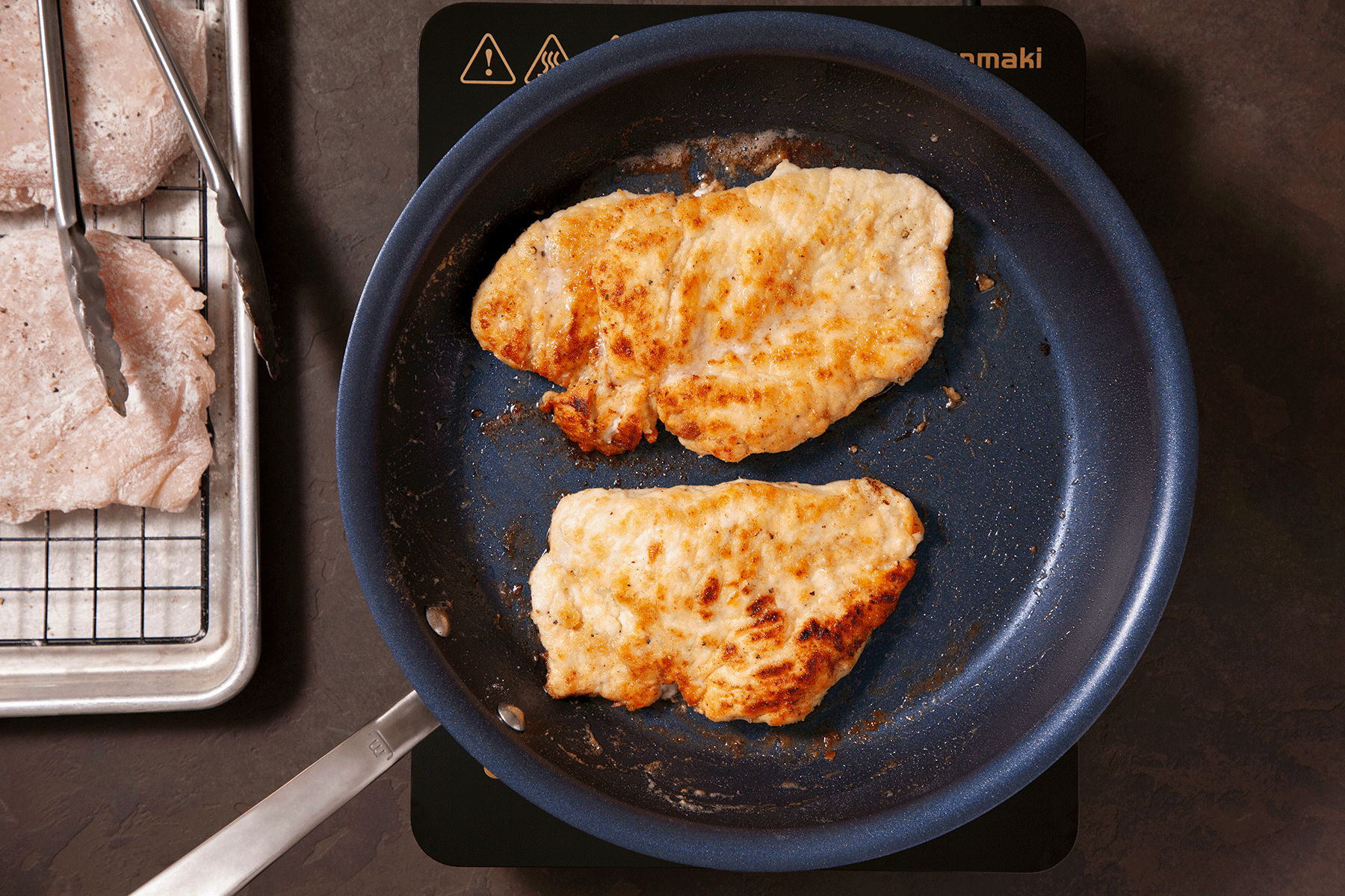 chicken searing in a skillet