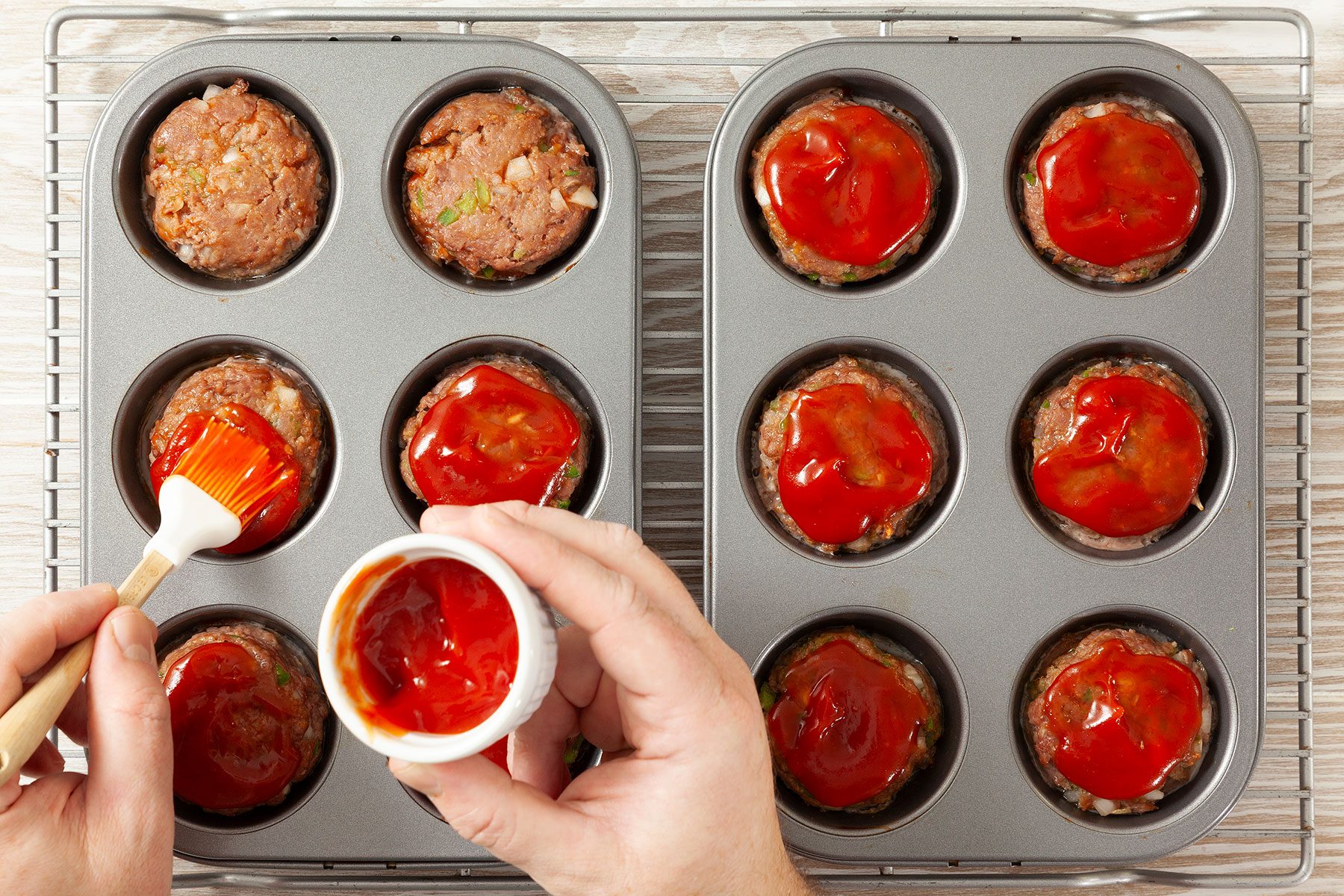 Brushing sauce on meat loafs