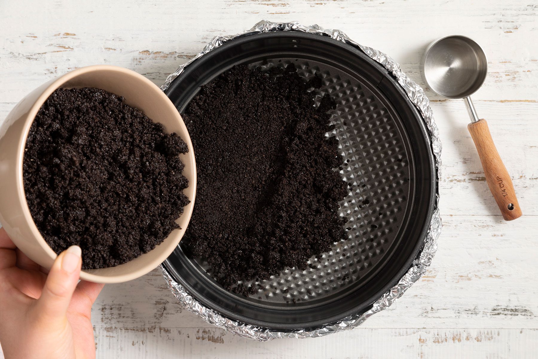 Putting cookie crumble on pan