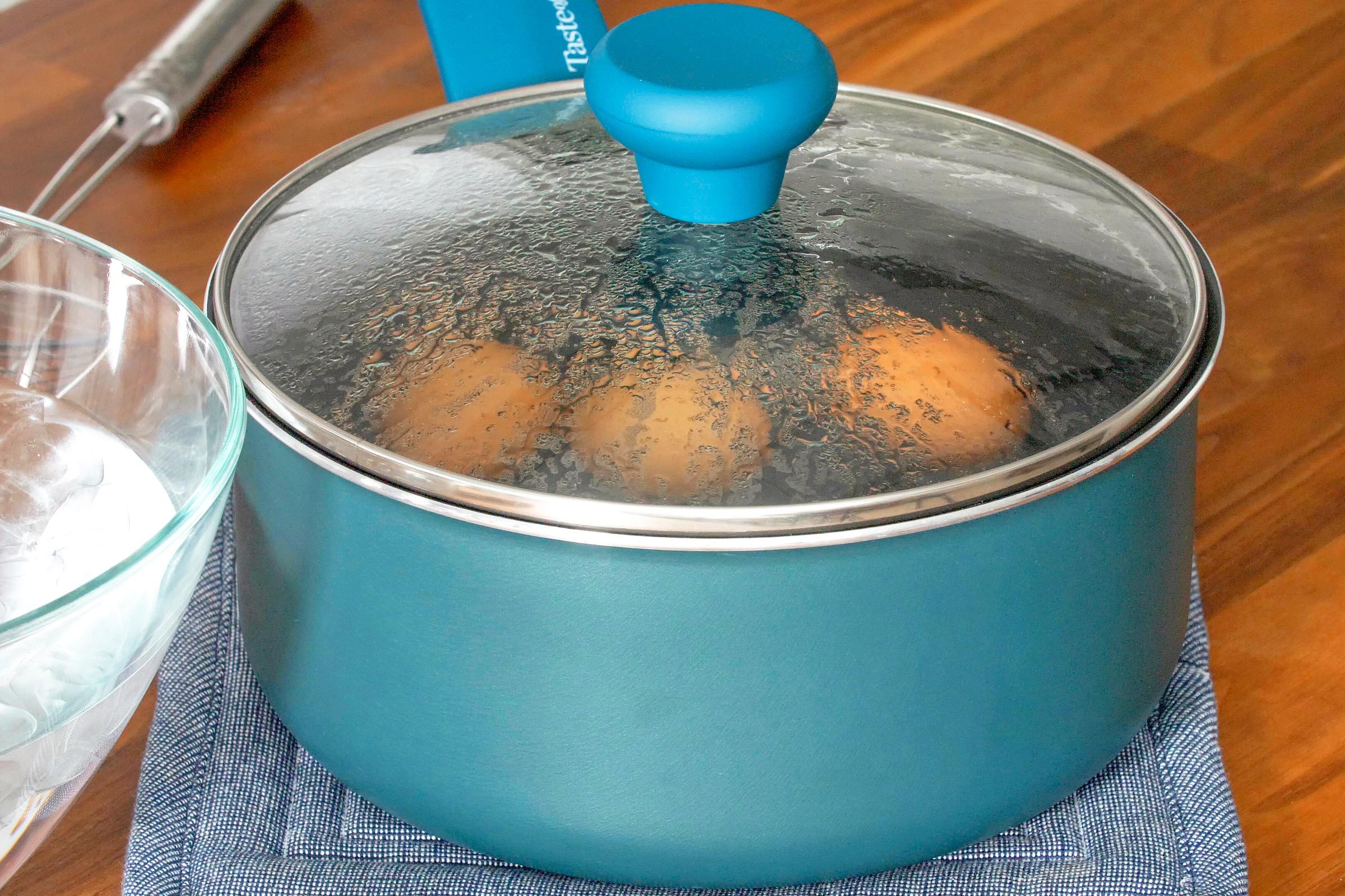 large pot with eggs and a lid, on a table