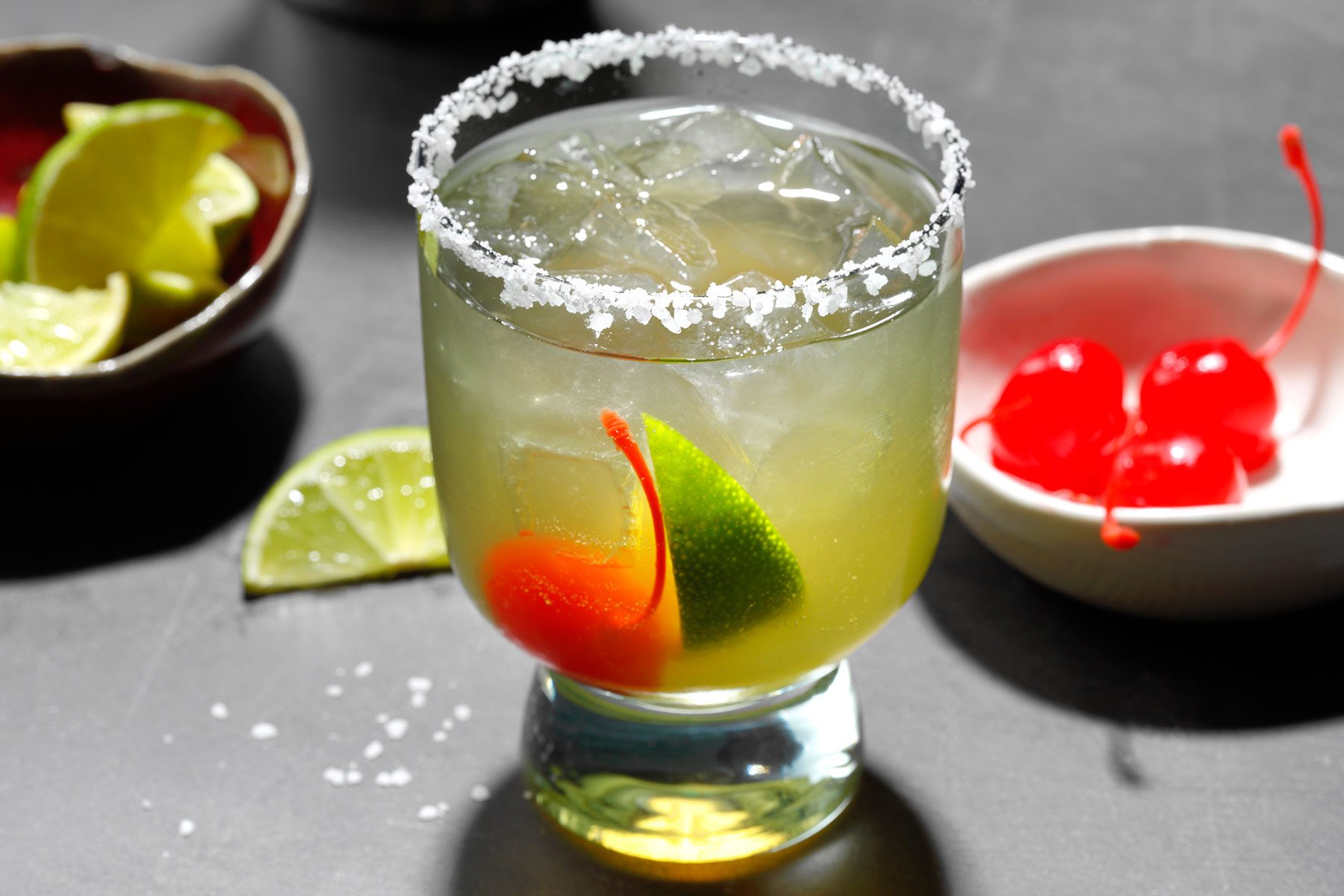 Italian Margarita served in glass with lemon wedge and cherry