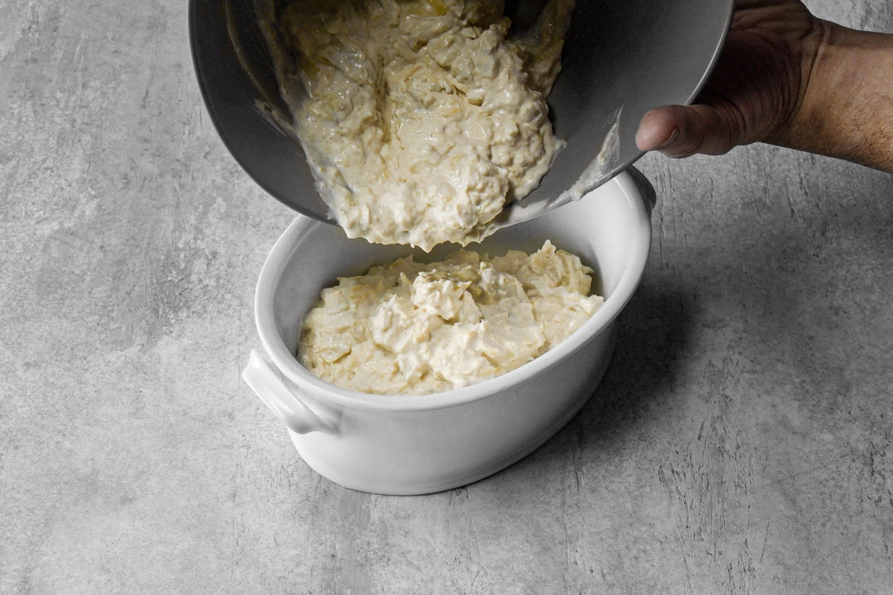 Artichoke Dip mixture is transferred to a baking dish