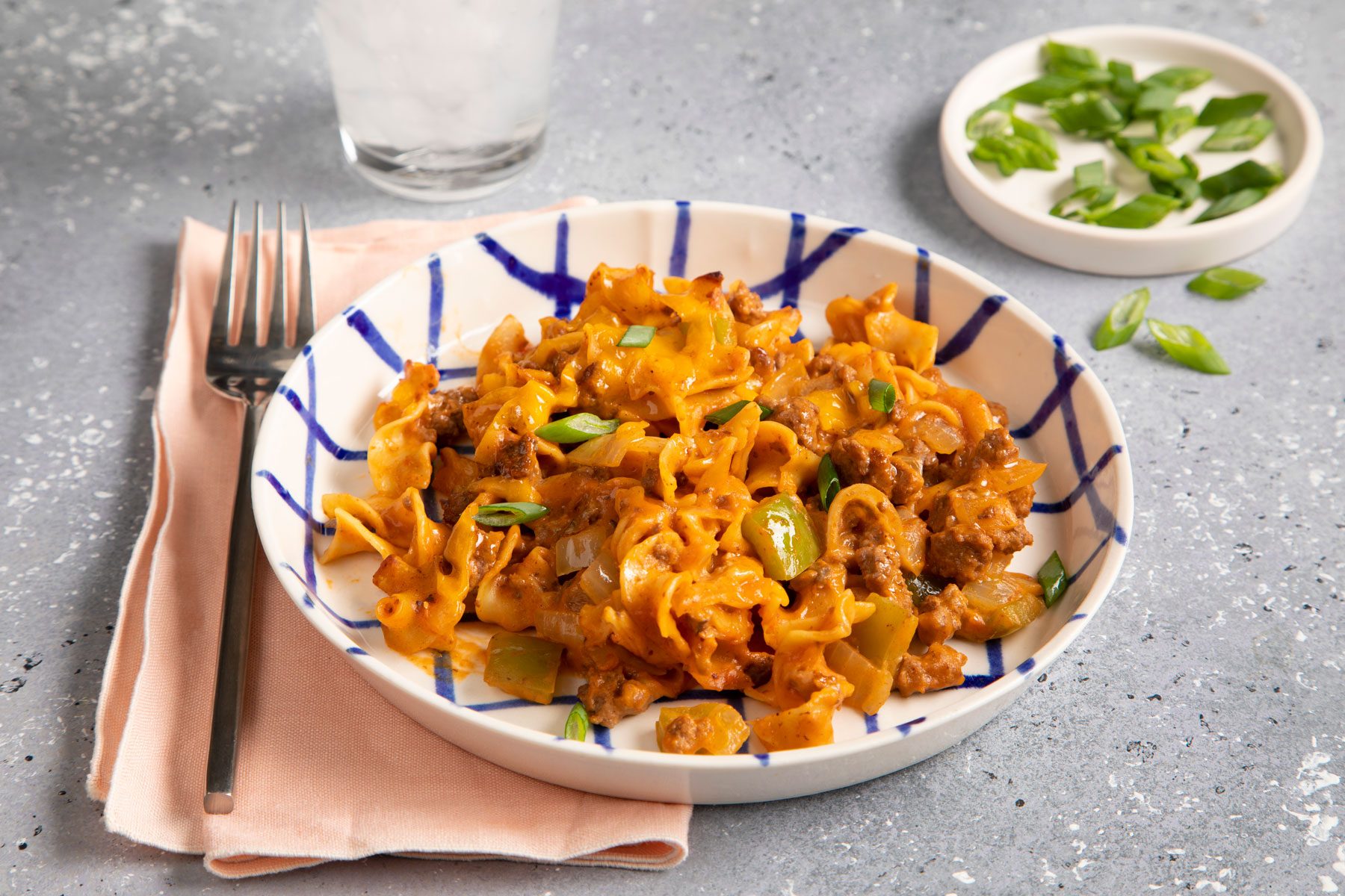 Beef And Noodle Casserole served in a plate with green onions