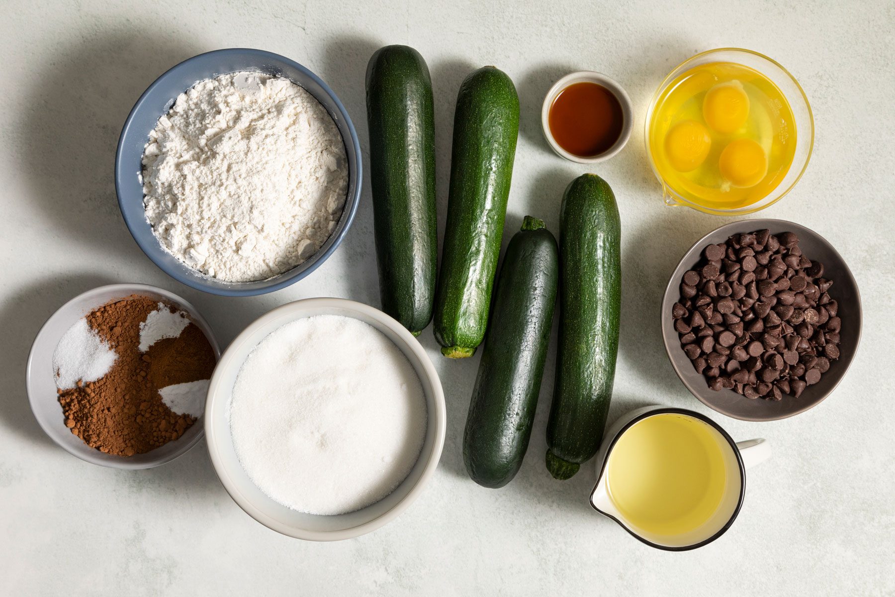 Baking cocoa Zucchini Chocolate chips and other ingredients placed on a kitchen countertop