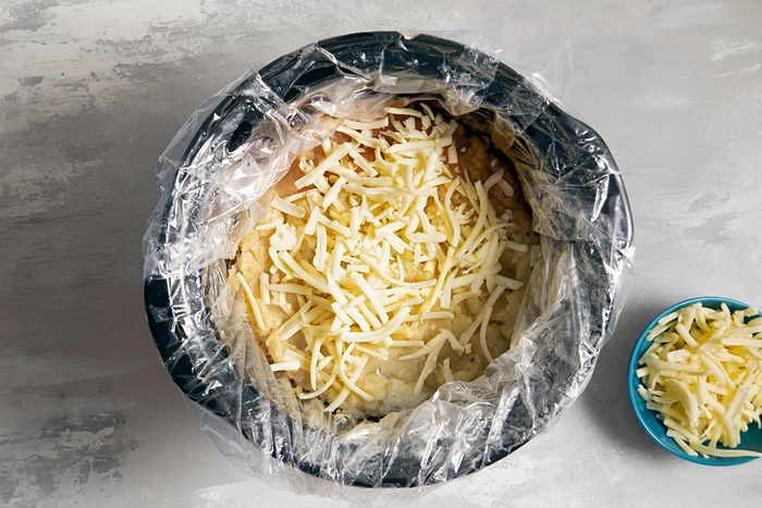 Spreading Cheese over meat mixture in slow cooker