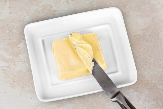 Sliced fresh butter curls in white container