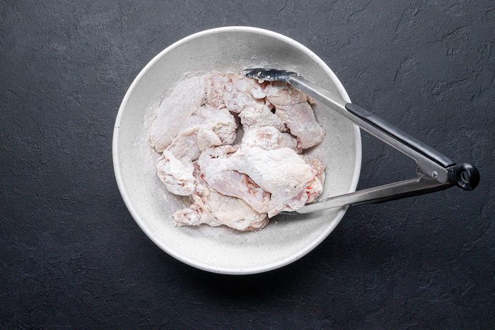 Coating Lemon Pepper Wings in flour