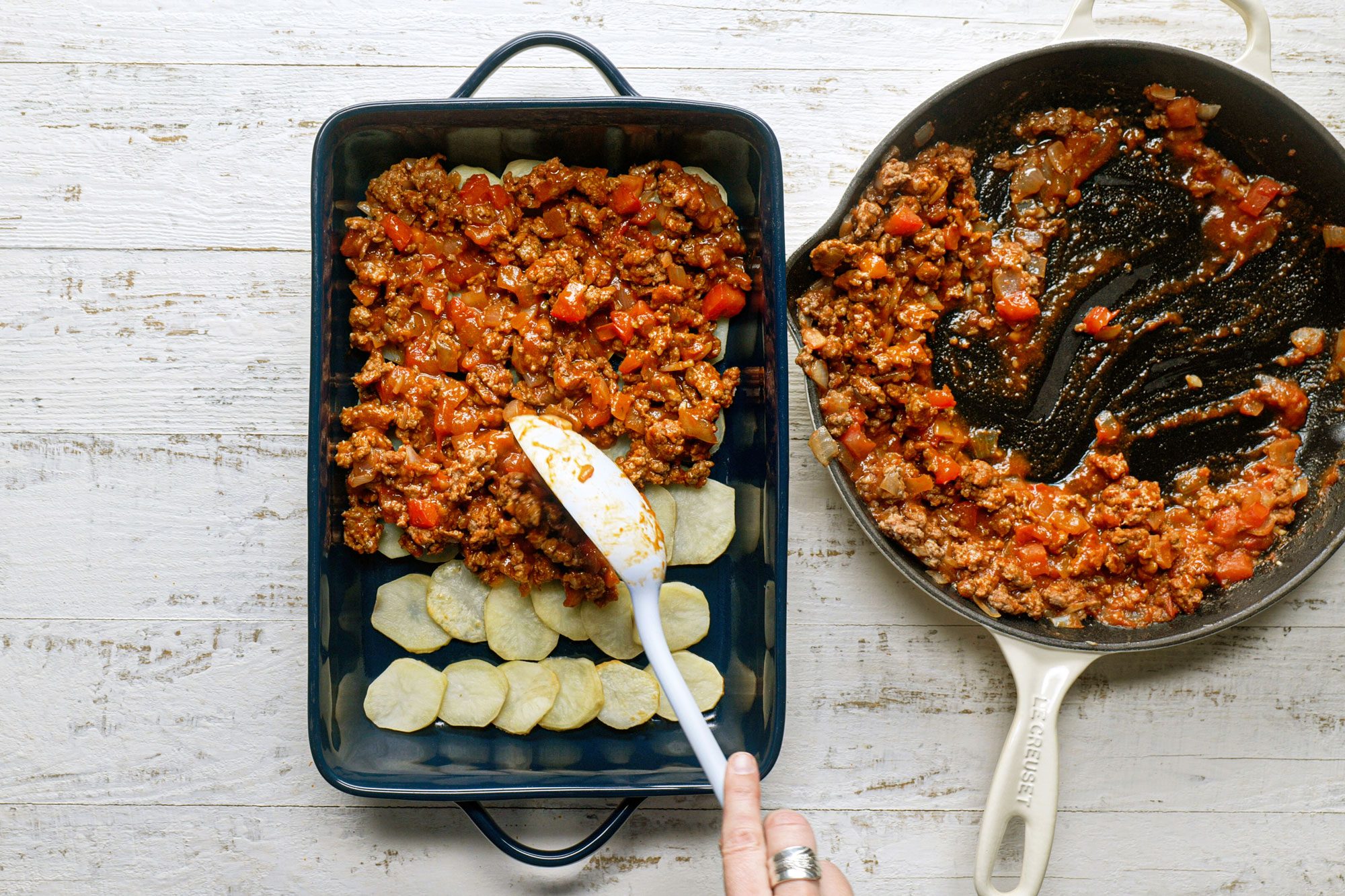 Arrange the par-cooked potato slices on the bottom of the dish and top it up with lamb mixture