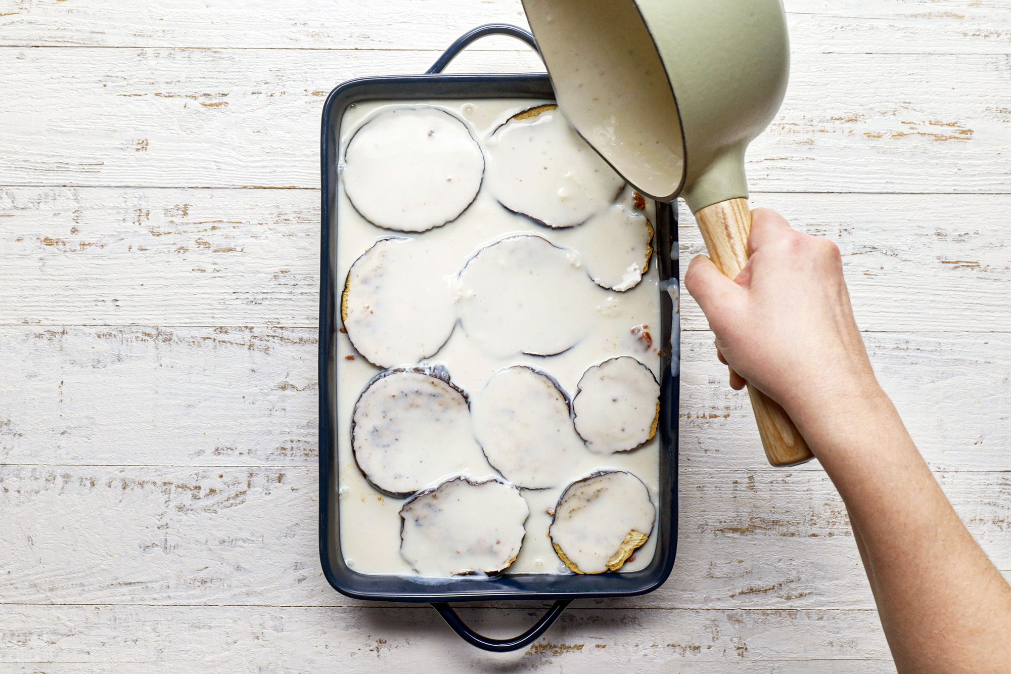 Pour the bechamel over the top of the lamb mixture