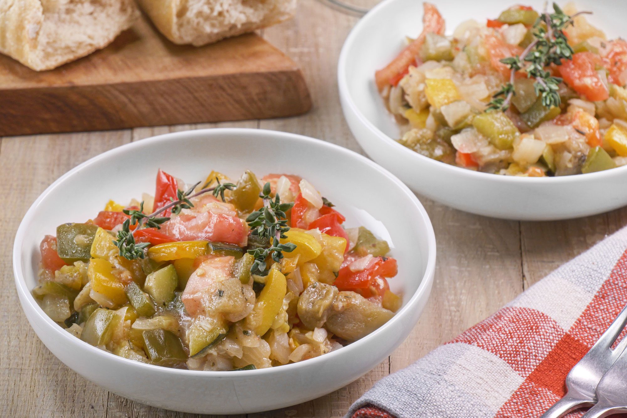 Classic Ratatouille served on two plates with knife and fork on the table