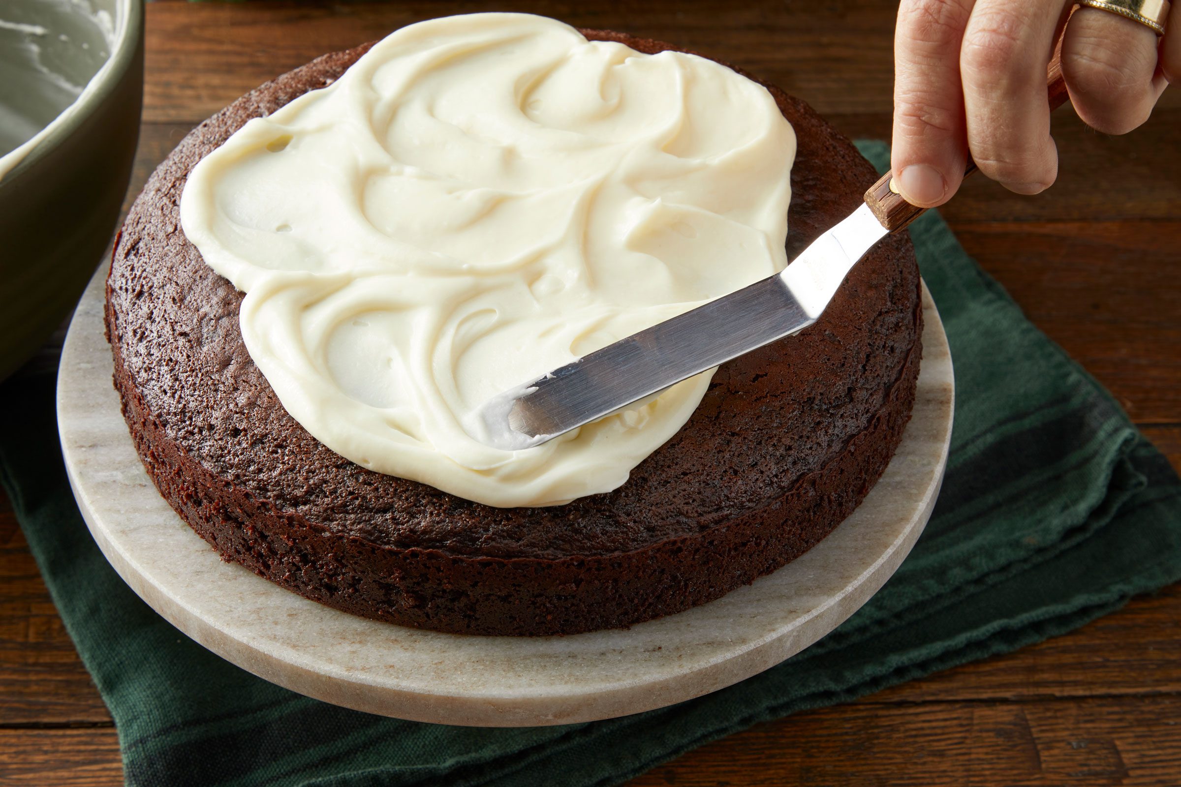 frosting a chocolate cake