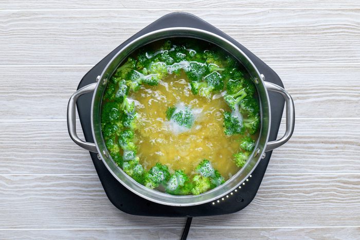 cooking broccoli in water on a hot plate