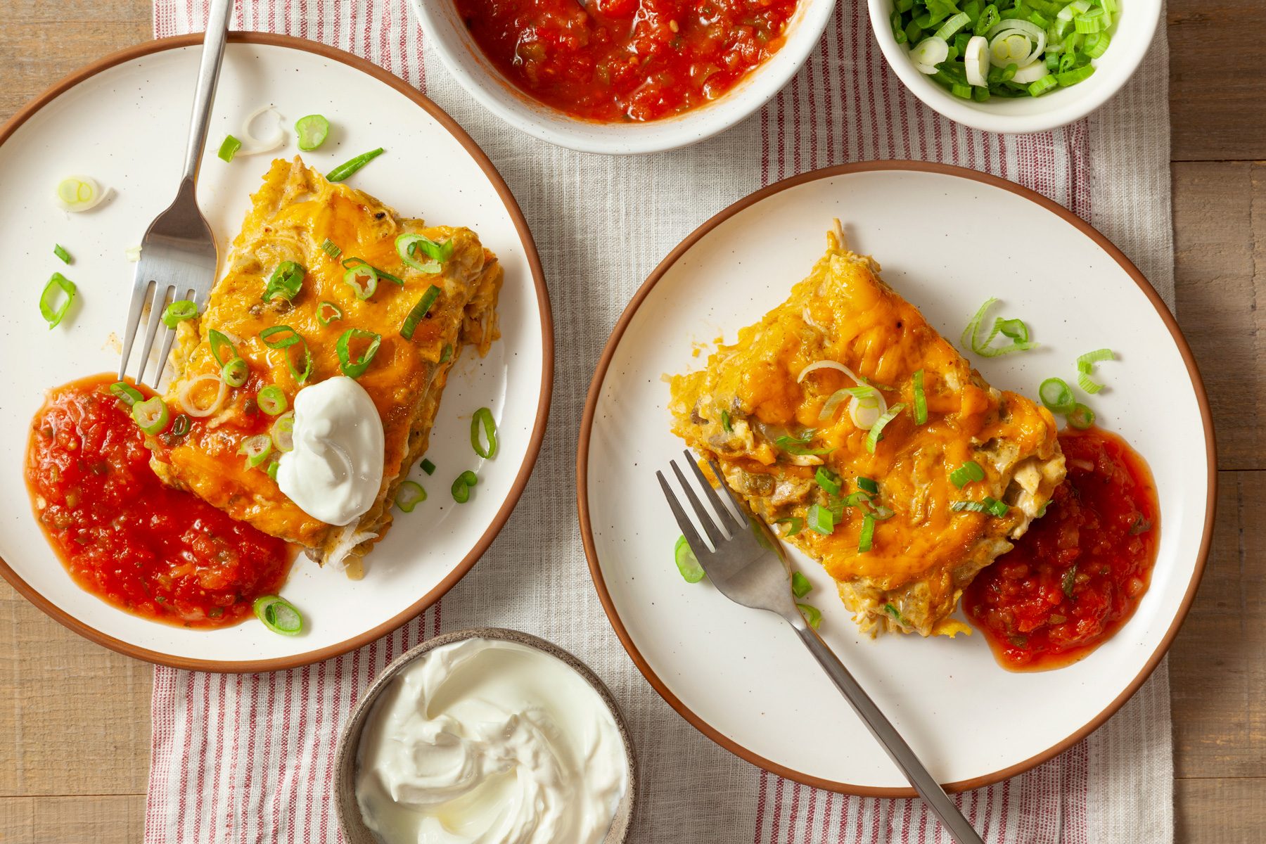 Two plates of chicken tortilla bake on a table