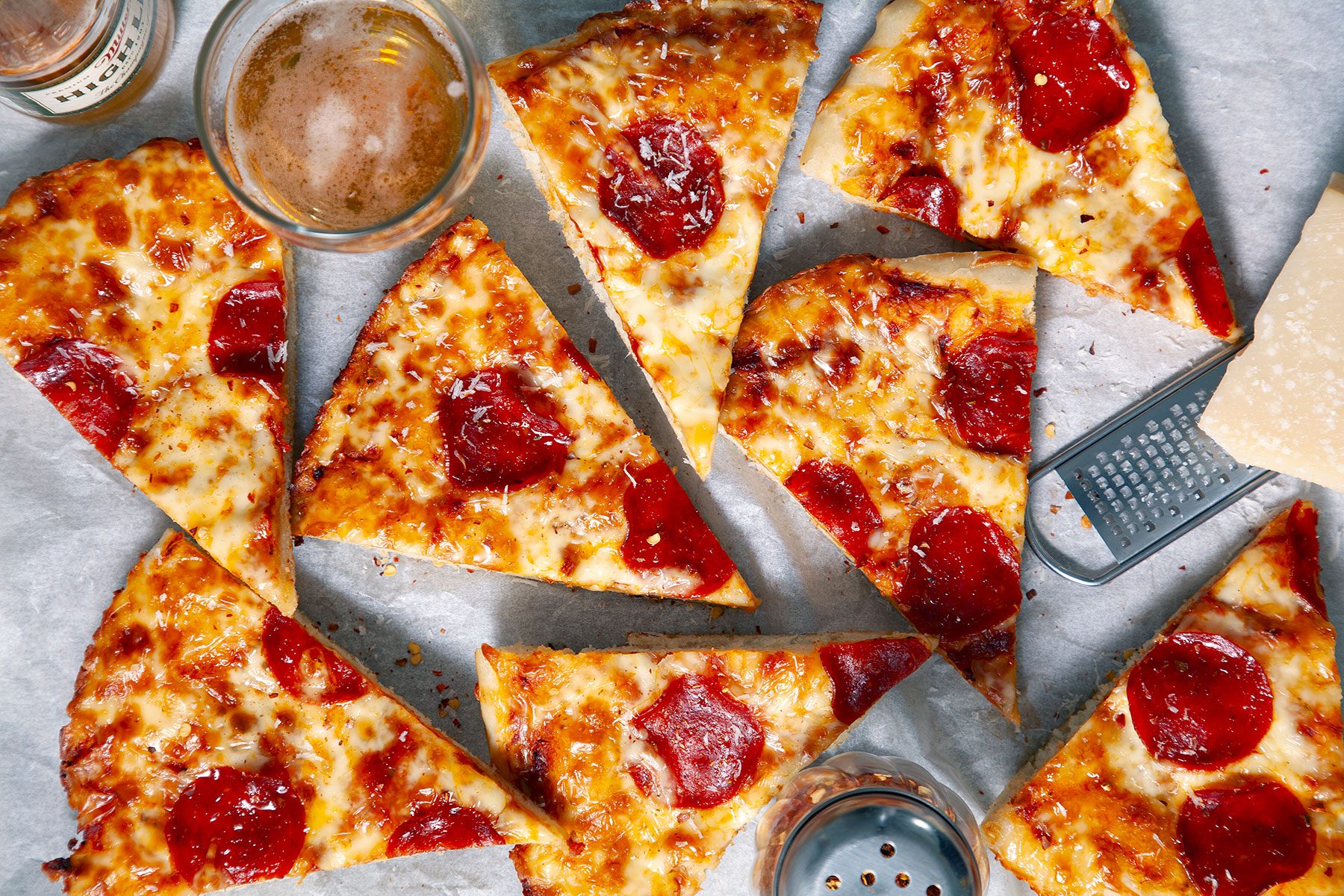Slices of Cast Iron Pizza with glass of drink on the side