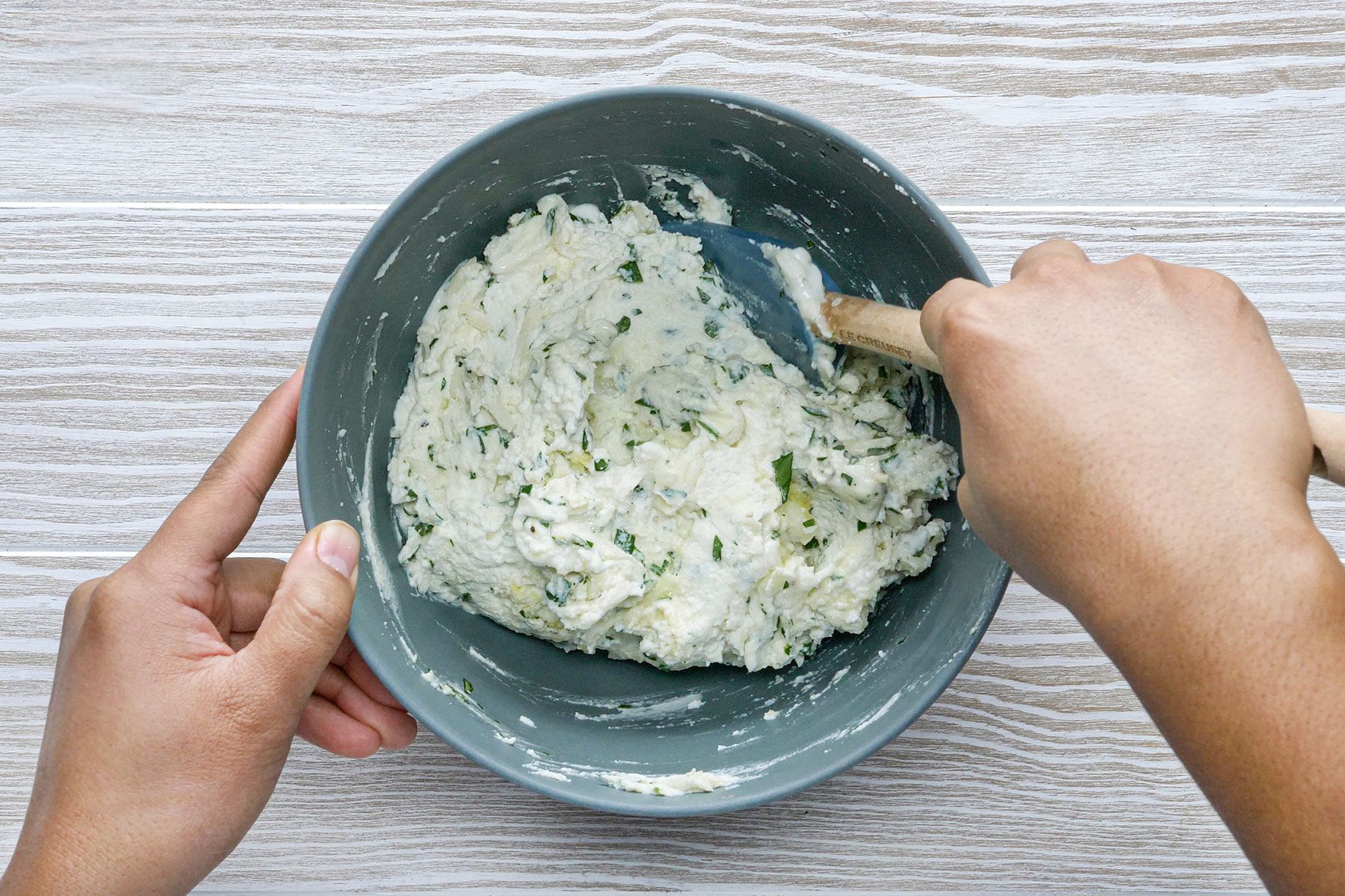 Making cheese filing in bowl with spatula
