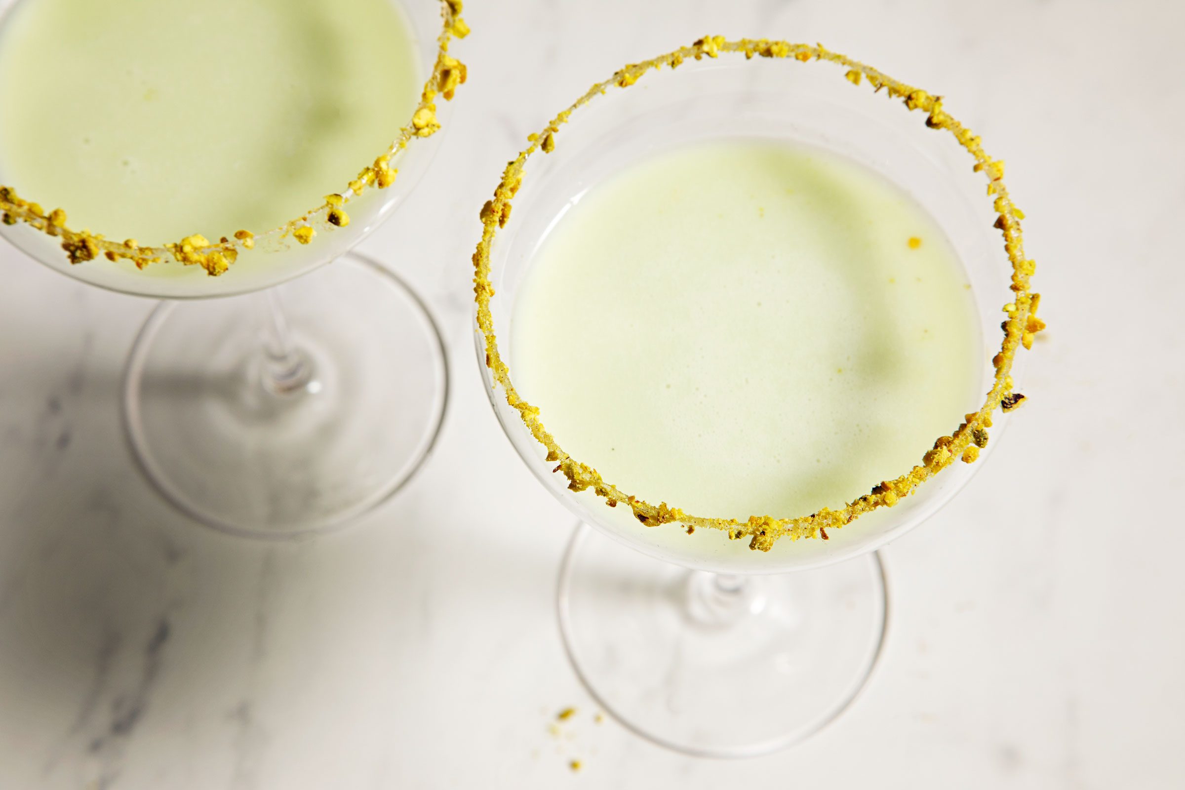 top view of two Pistachio Martini served in glasses with a decorated rim