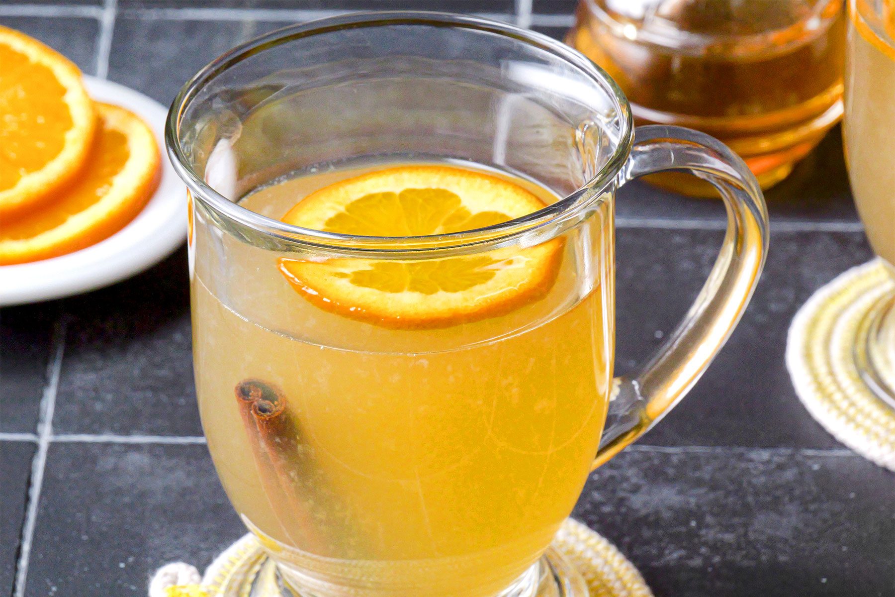 Hot Toddy served in large mug with orange slice and cinnamon stick