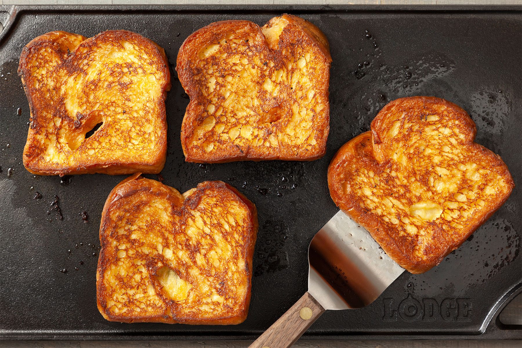 Overhead shot of cooked on griddle; until golden brown on both sides; flat spatula;