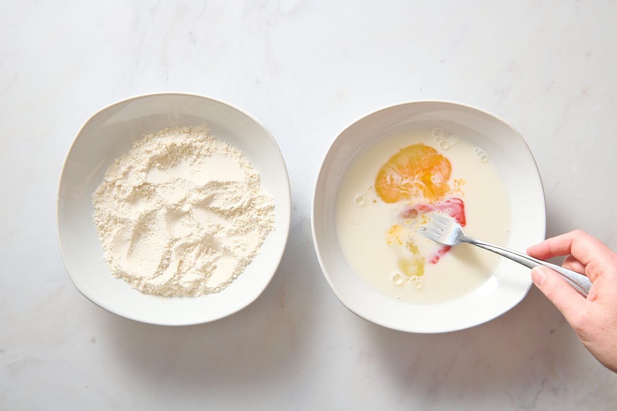 Two bowls filled with the ingredients to coat the chicken fried steak