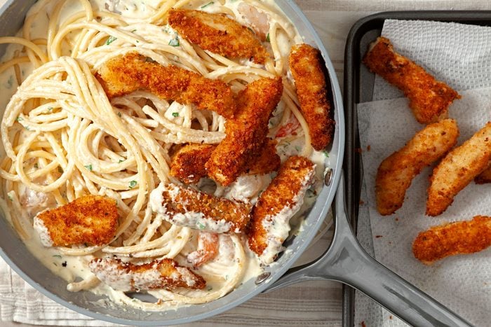 Add the al dente pasta and the red pepper strips to the sauce