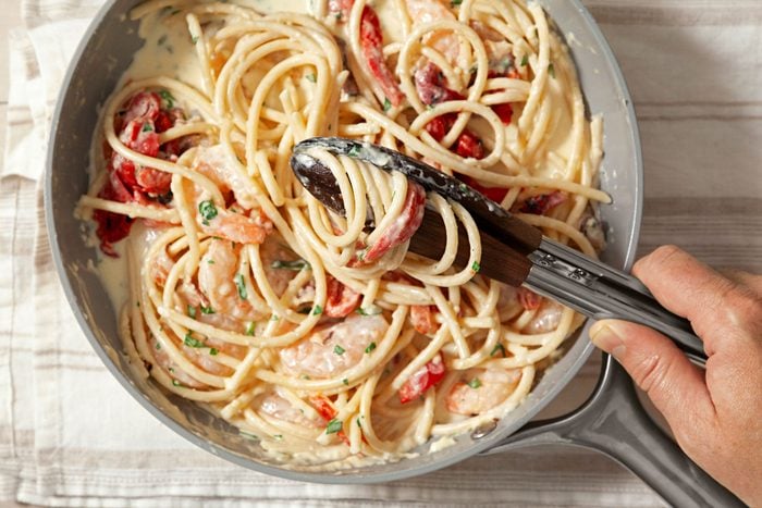 Gently fold the fried chicken in the pasta