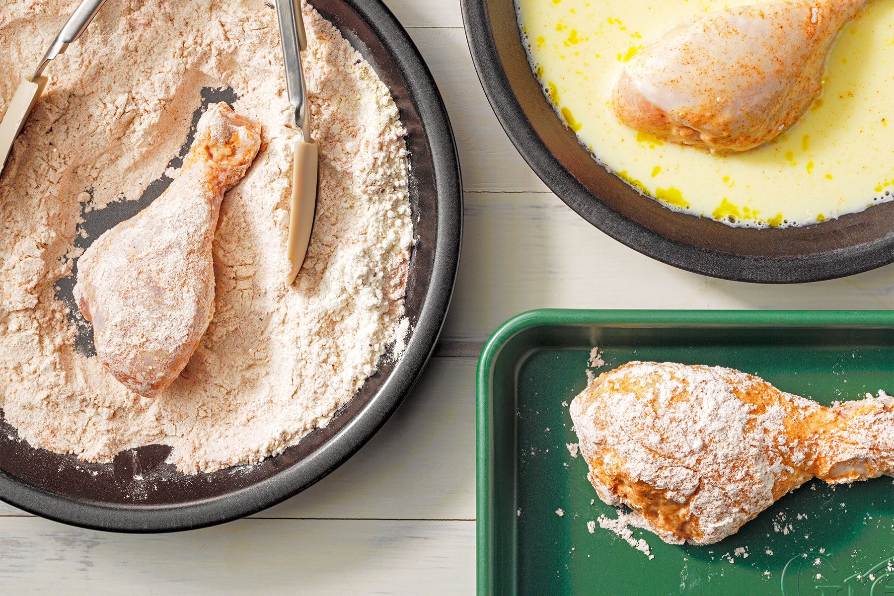 Overhead shot of place chicken in flour mixture; a few pieces at a time; turn to coat; shaking off excess; dip chicken in egg mixture; coat again in flour mixture; wooden background;