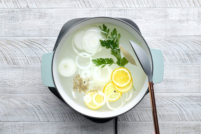 In a large saucepan, combine water, onion, lemon, parsley, salt, peppercorns, bay leaf and thyme