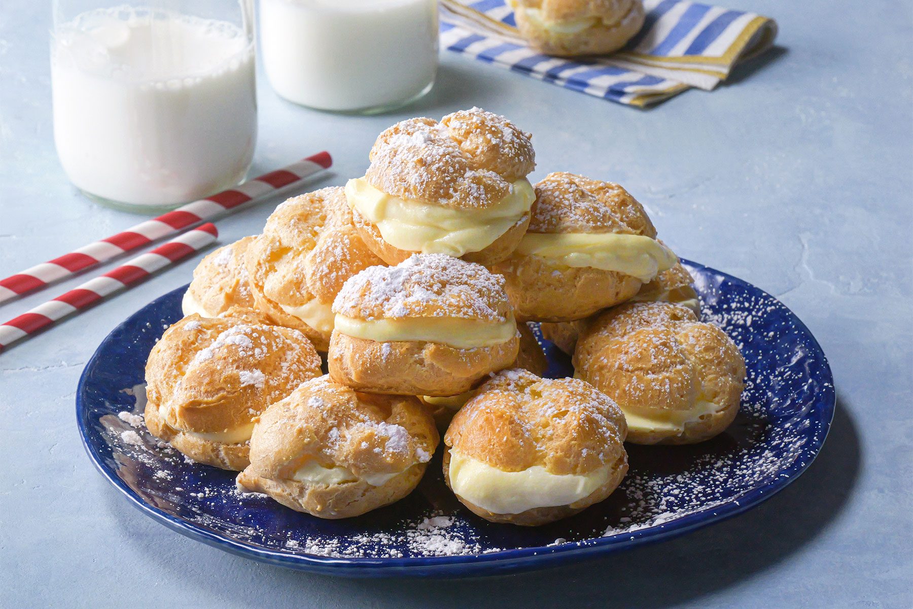 close shot of mini cream puffs served with milk