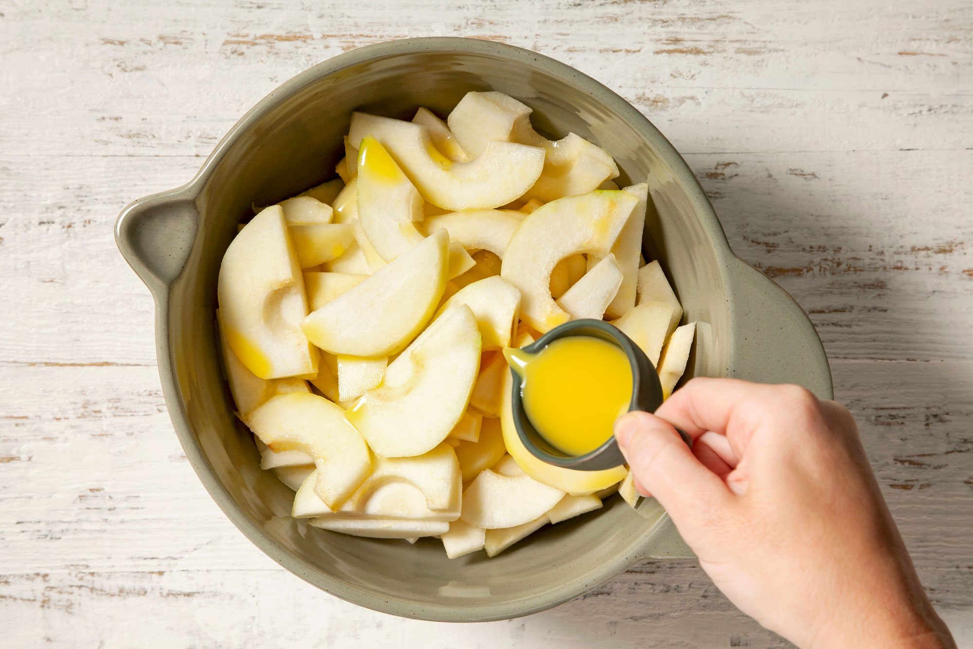 Toss the pears with orange juice and place them in a greased