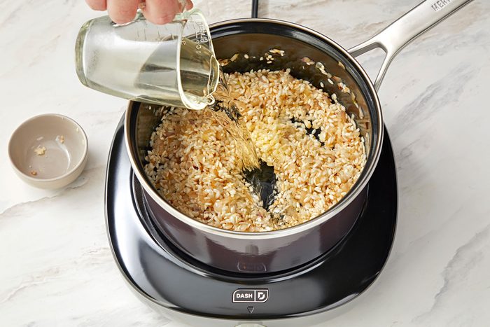 pouring wine into a saucepan