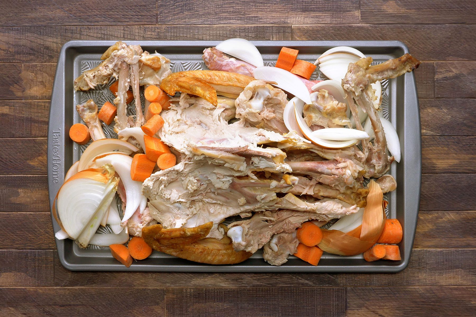 overhead shot of turkey carcass, vegetable in a baking dish