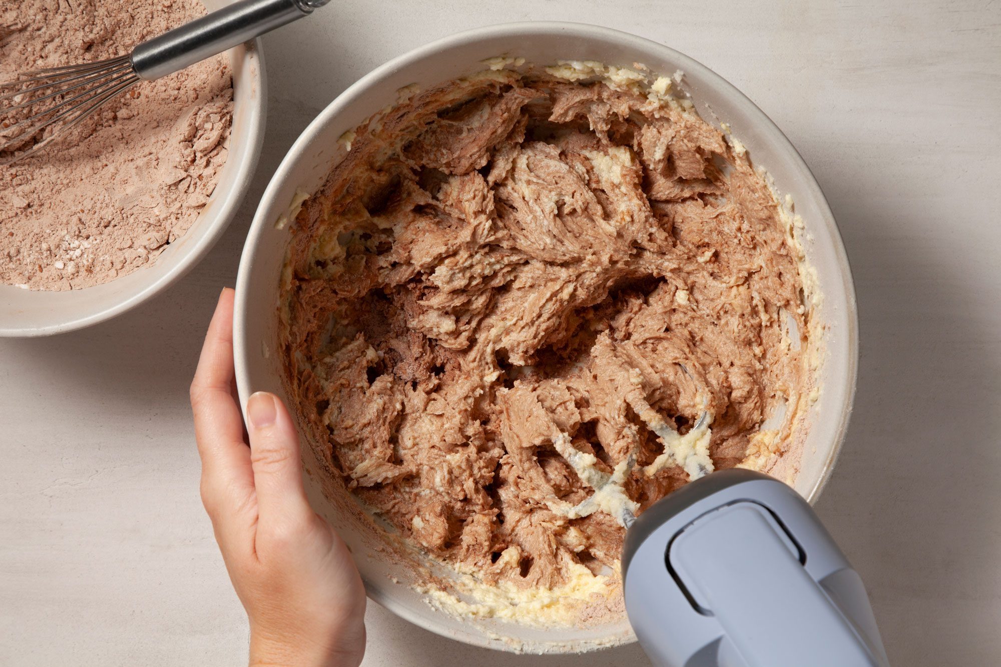 Overhead shot of gradually add to creamed mixture; beating machine; marble background