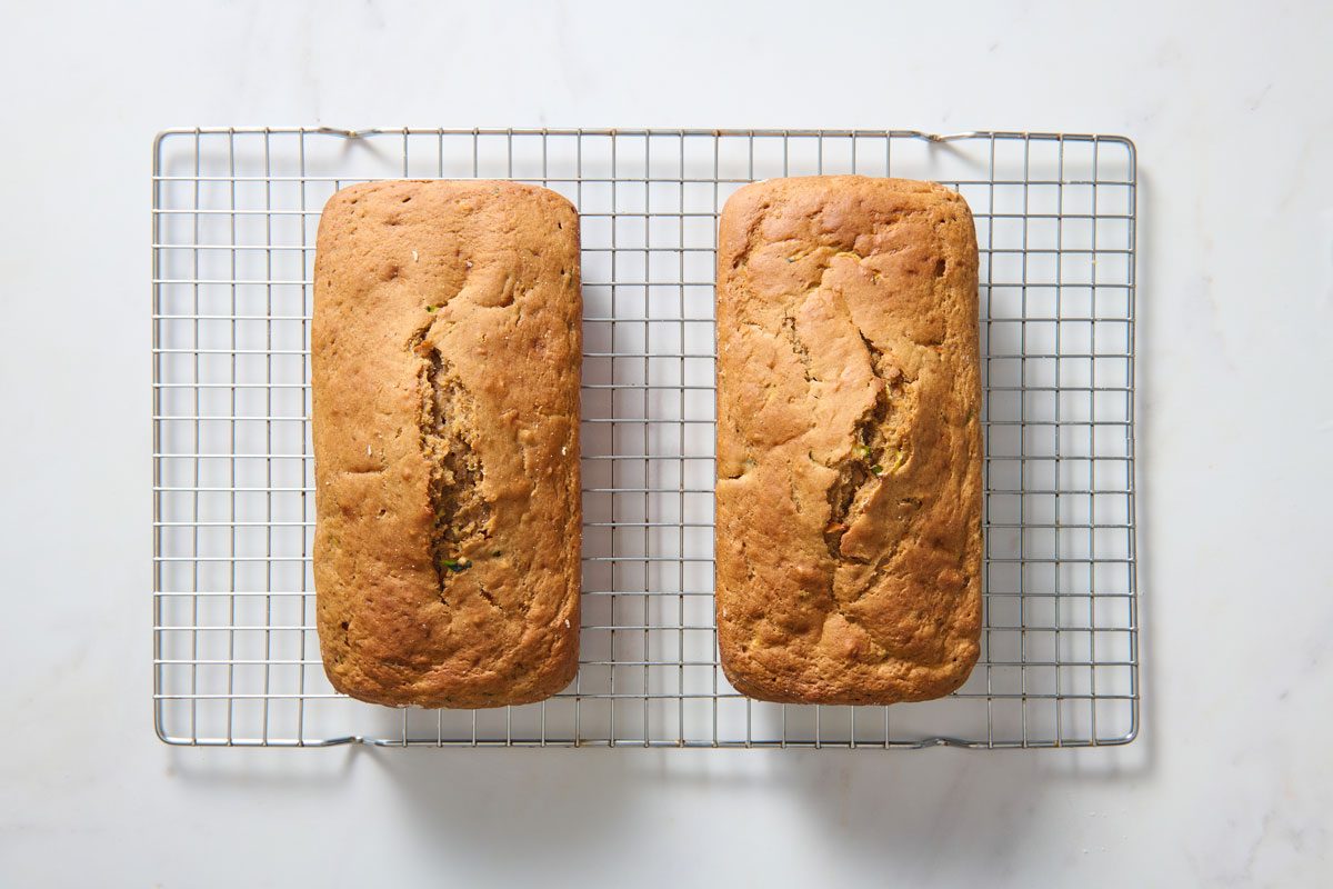 two baked loaves of zucchini carrot bread on cooling rack