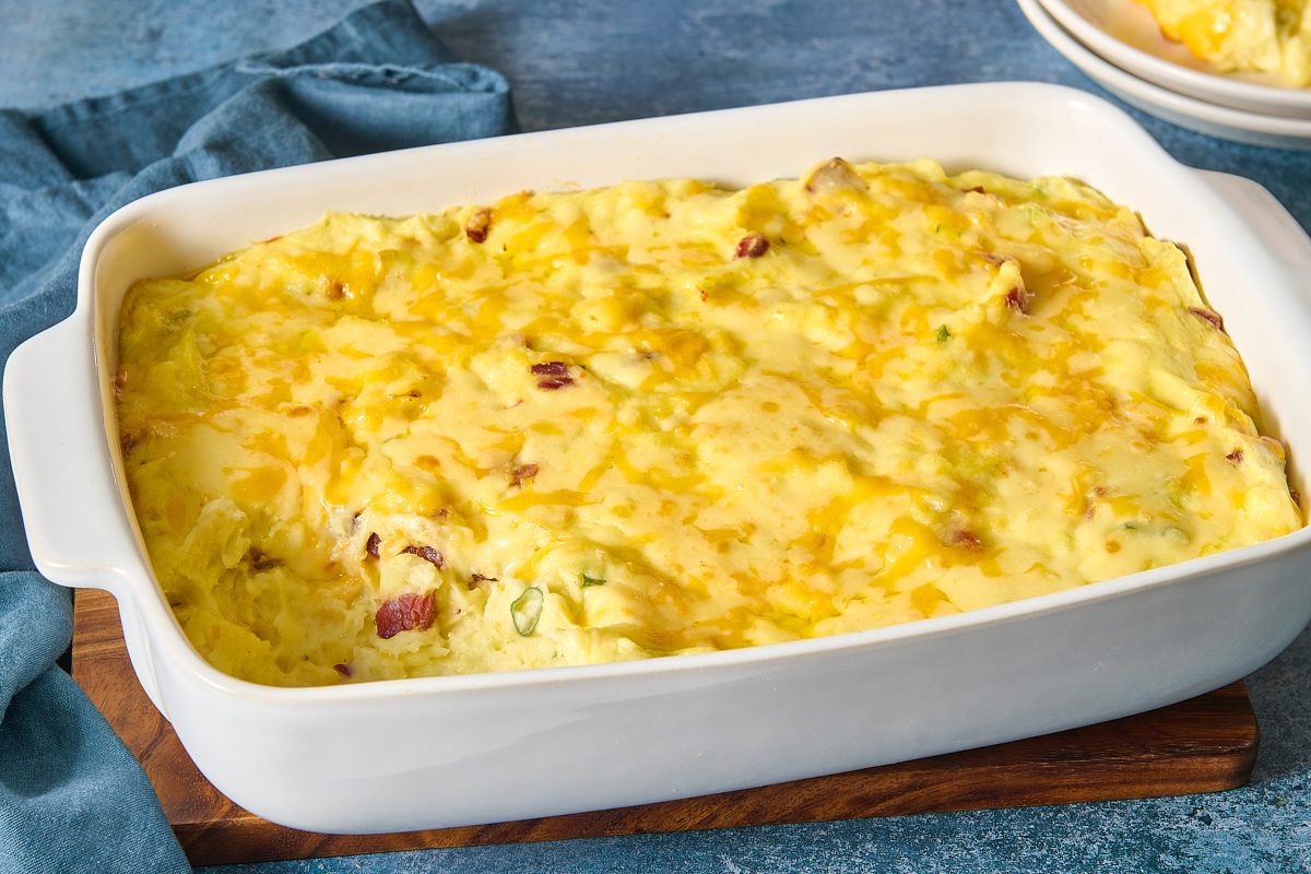 Closeup of loaded mashed potatoes with a portion scooped out