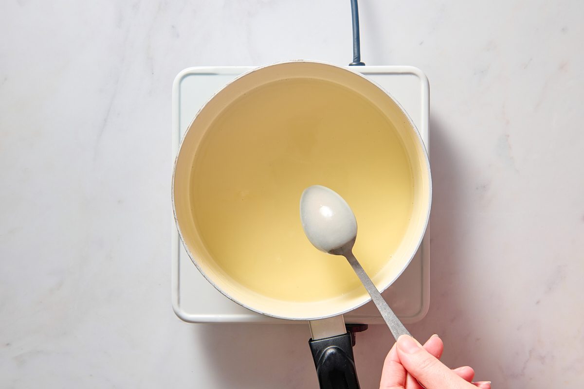 Hot milk mixture coating the back of a spoon