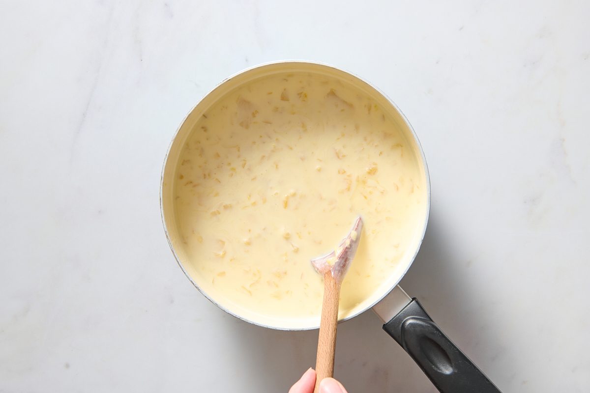 Stirring pineapple into the cooled milk mixture