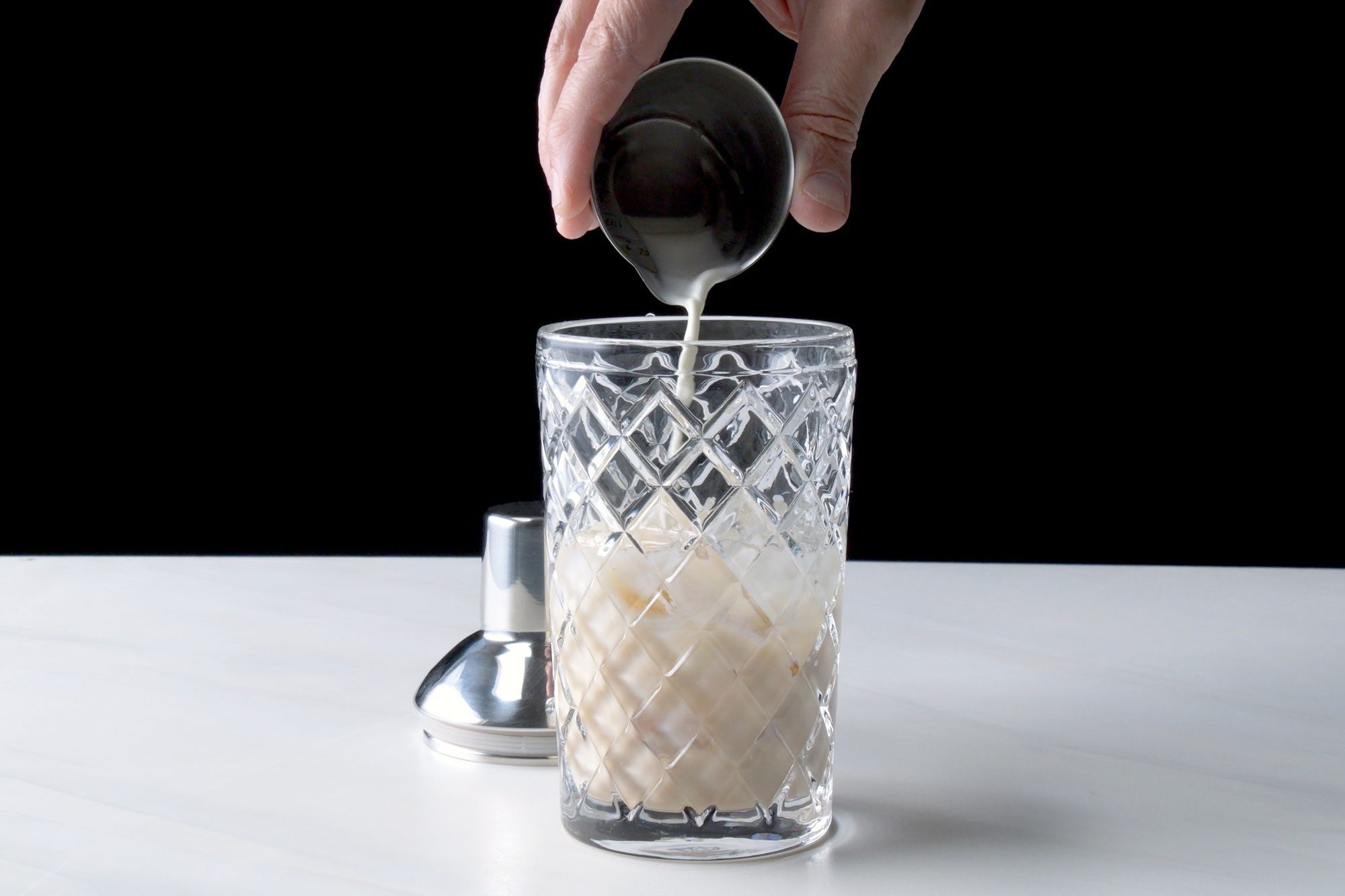 Strain the cocktail into the prepared glass