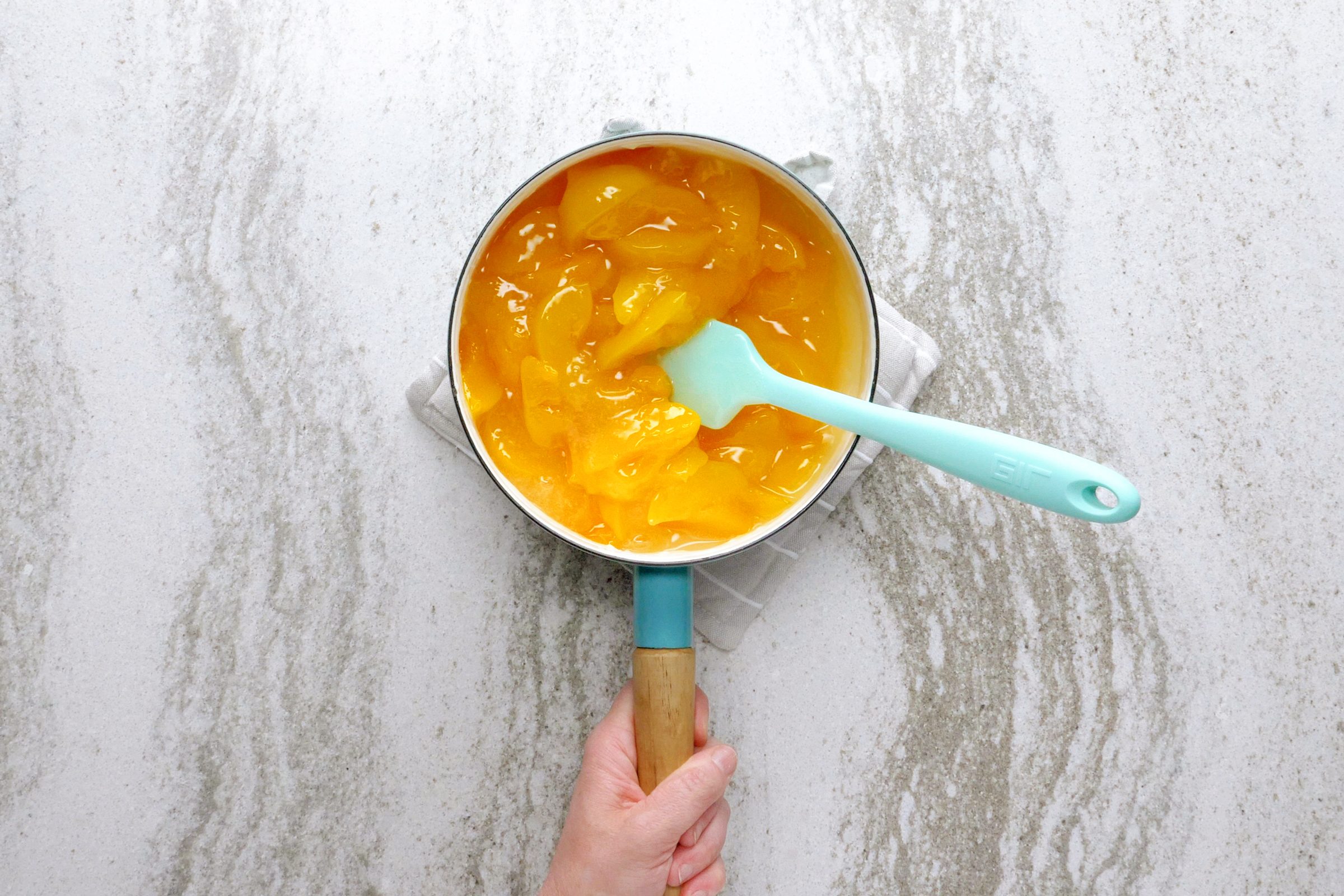 peaches in a pot on the stove for peach crisp