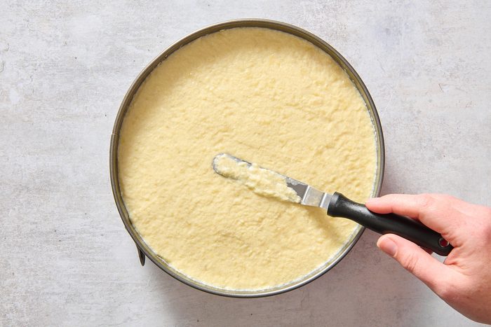 Smoothing the top layer of the cake with a spatula